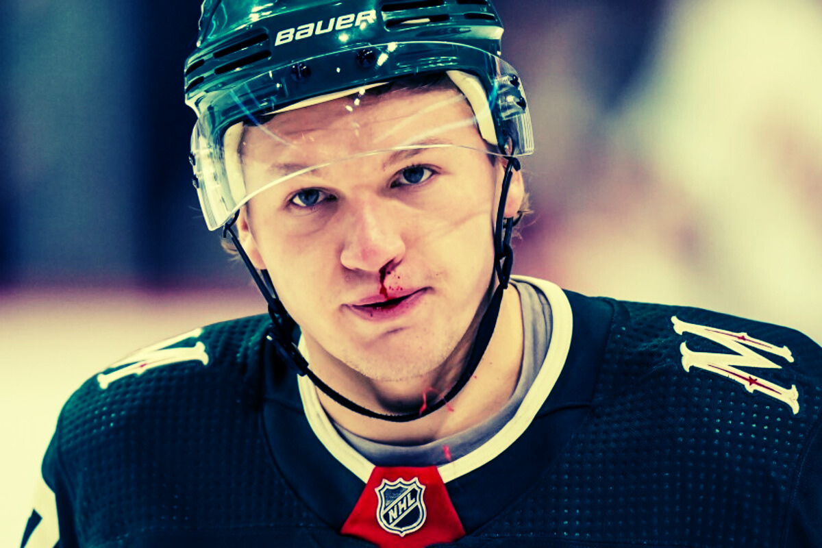 Kirill Kaprizov in action during a Minnesota Wild game, showcasing his skill and focus on the ice.